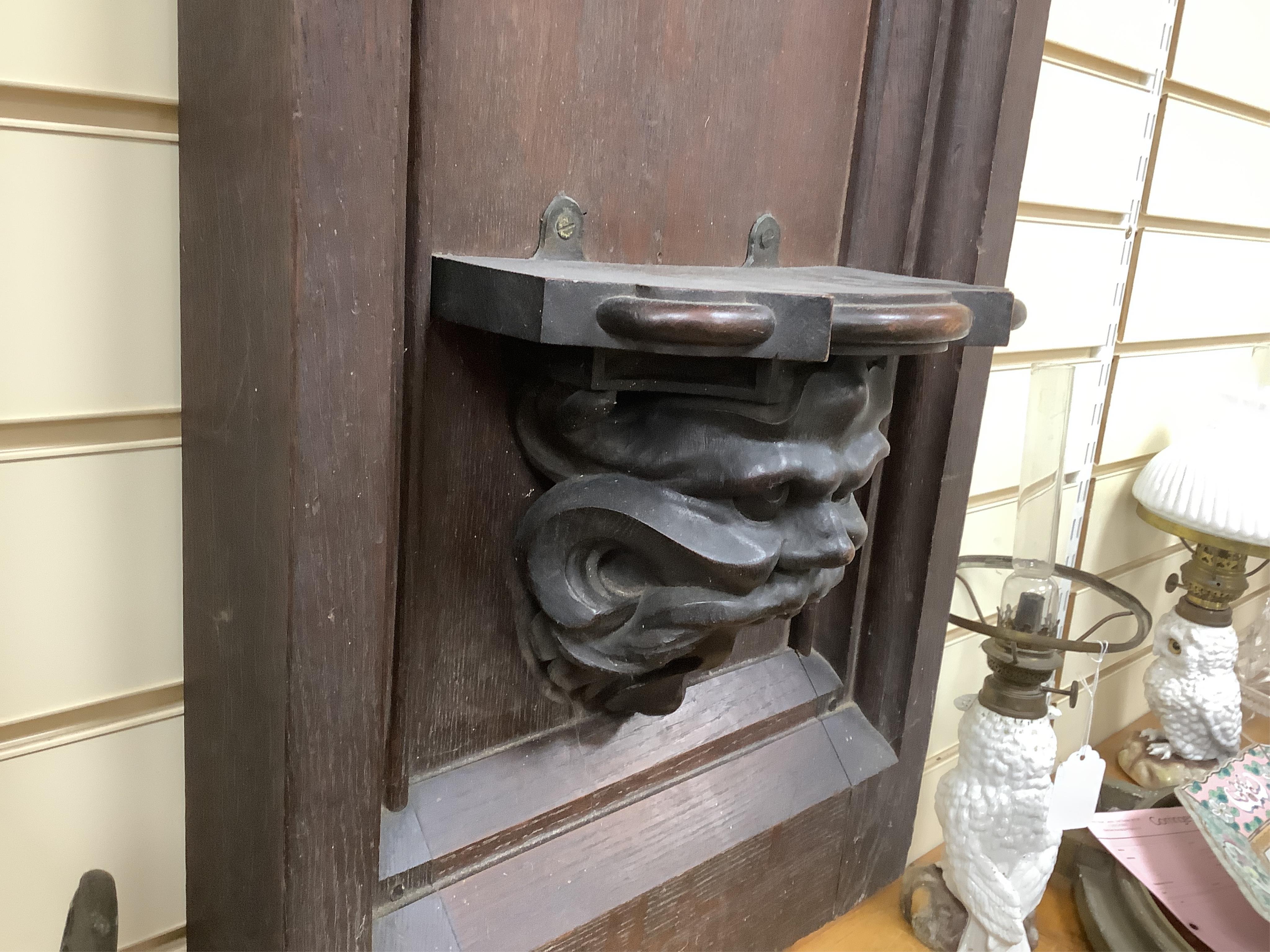 A 19th century Gothic revival carved oak wall bracket carved with Gothic tracery and the head of Moses, height 86cm, width 41cm. Condition - good